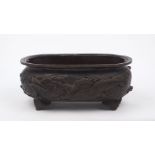 A Japanese bronze oval jardiniere, late 19th century, cast in relief to the exterior with hawks in