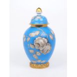 A Rosenthal porcelain jar and cover, 20th century, painted en grisaille with roses on a blue