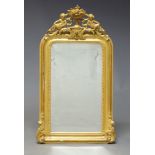 A Continental gilt gesso wall mirror, late 19th, early 20th Century, of arched form, the pierced