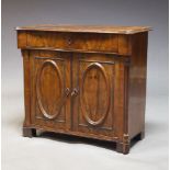 An early Victorian mahogany chiffonier, the quarter veneered serpentine top above frieze drawer