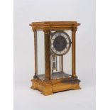 A gilt metal and glass sided mantle clock, 20th Century, in a neo-classical case with Corinthian