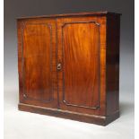 A Victorian mahogany cabinet, with two paneled doors enclosing two shelves, raised on plinth base,