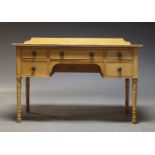 A pine serving table by Maple & Co, second half 20th Century, with five drawers raised on turned