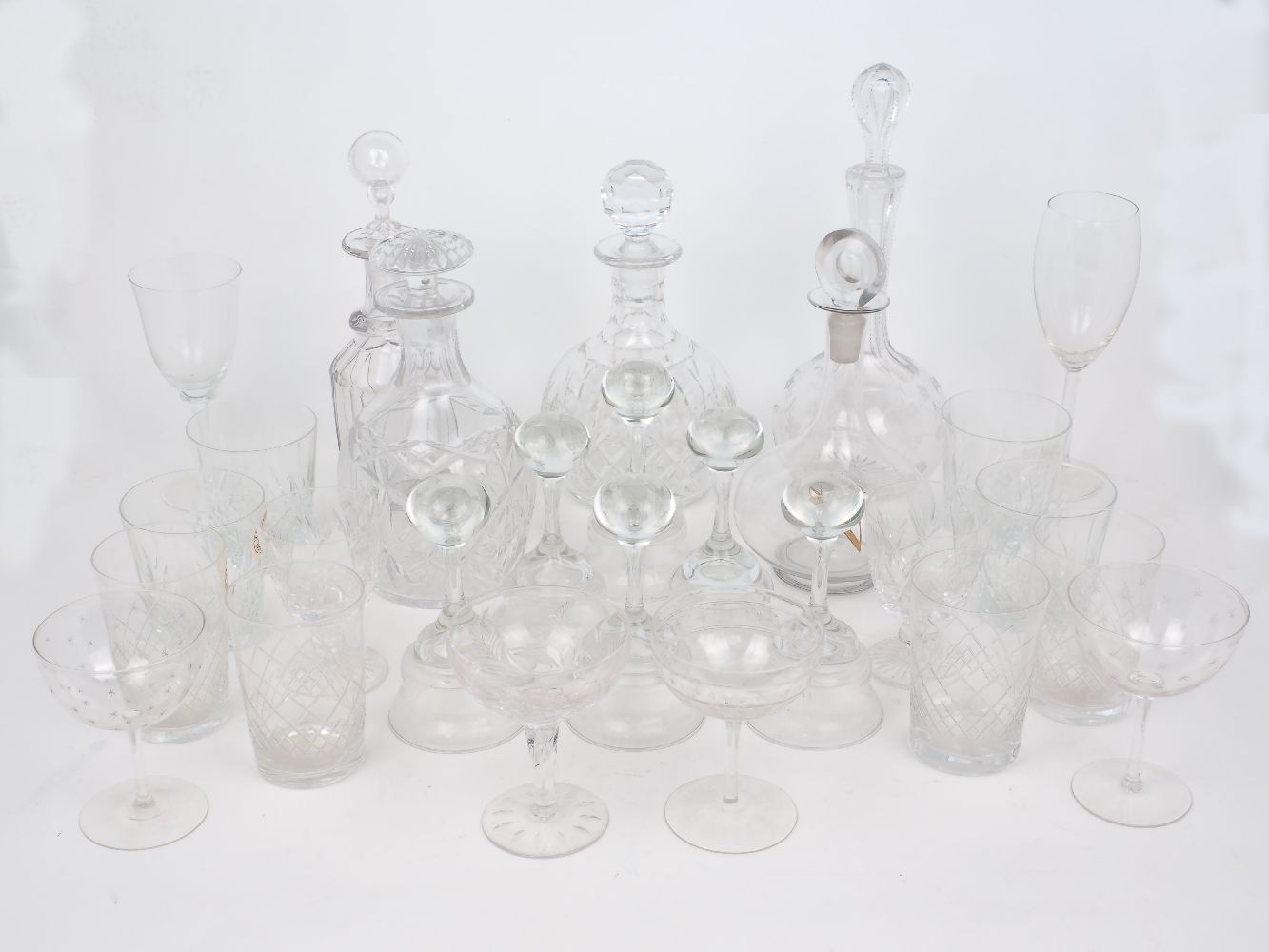 A mixed group of clear glass drink ware comprising: a decanter with an associated stopper and four