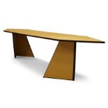 Andrew Kindler, a modern chipboard dining table, of recent manufacture, the shaped top on two