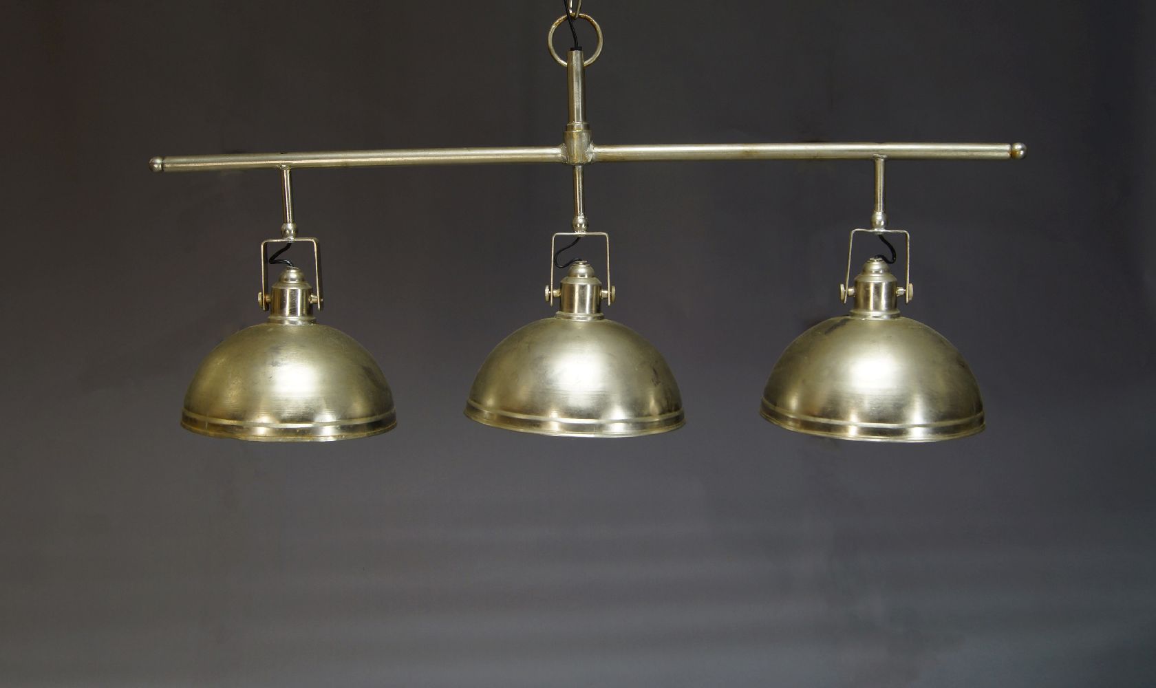 A industrial style three light pendant light, late 20th Century, with three shades suspended from