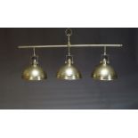 A industrial style three light pendant light, late 20th Century, with three shades suspended from