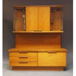 A teak and glazed cabinet, c.1970, the top section with two cupboard doors enclosing two shelves