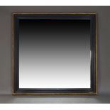 A large ebonised and parcel gilt overmantle mirror, second half 20th Century, of rectangular form in