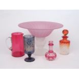 A decorative glass centrepiece, designed with pink flared bowl, to lobed stem and spreading foot,