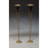 A pair of Mid Century style uplighter floor lamps, on four cylindrical supports to circular base,