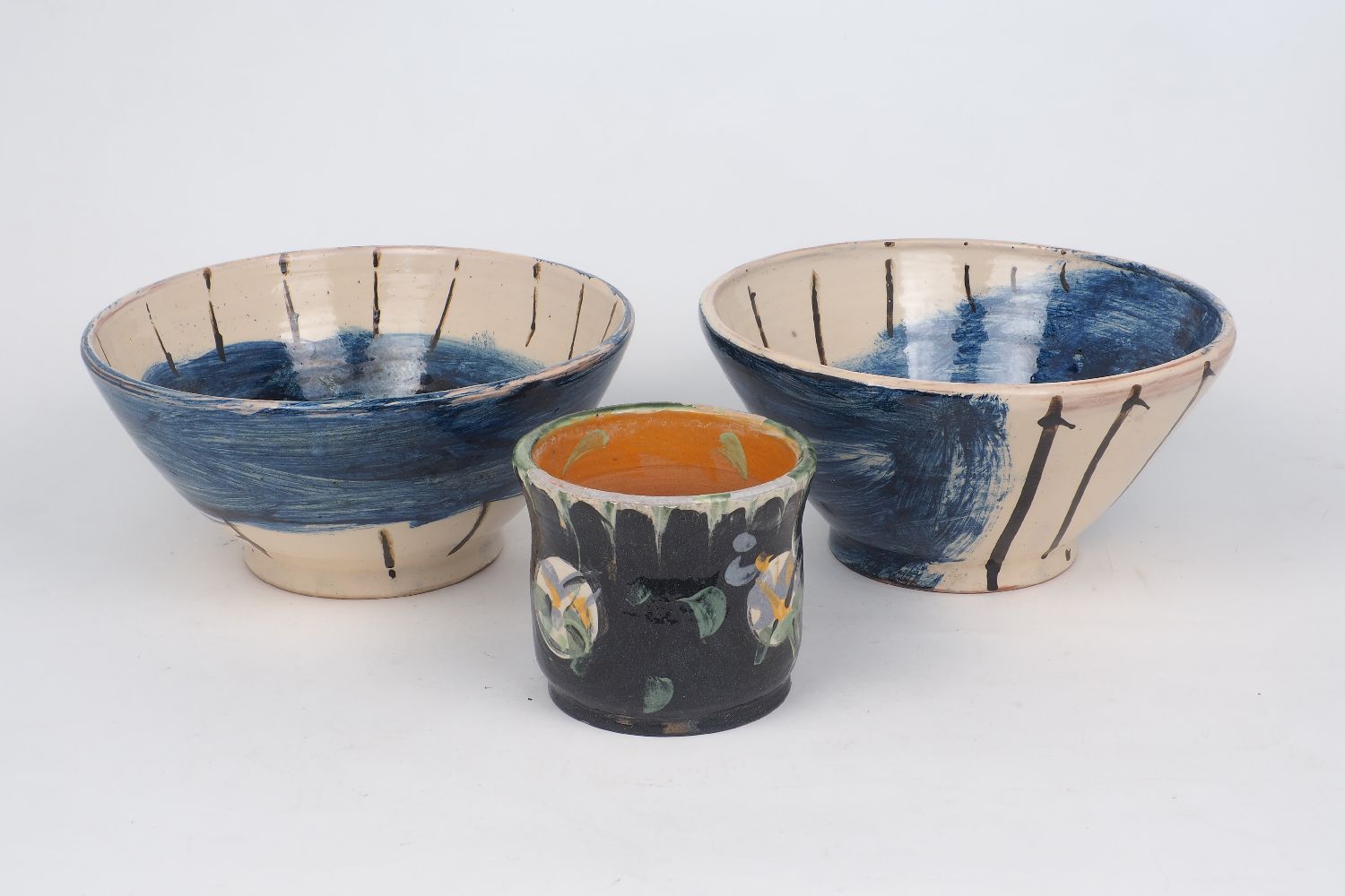 David Garland (1941-), c.1990, signed to base, two cream glazed bowls with blue and brown