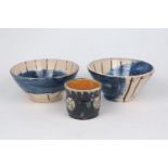 David Garland (1941-), c.1990, signed to base, two cream glazed bowls with blue and brown