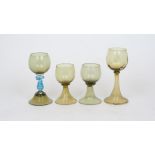 Four German green glass hock glasses, late 19th/early 20th century, to include: a pair, 12cm high, a