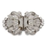 Two Art Deco platinum and diamond brooches, of matching shield shaped design composed of circular