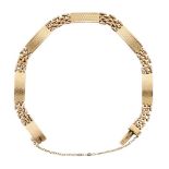 A bracelet, composed of engraved curved rectangular panels with flexible brick link sections