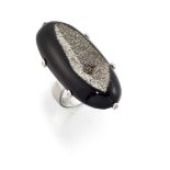 An onyx, ruby and iron pyrite ring, the oval, shaped concave onyx with central circular-cut ruby