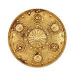 A late 19th century Archaeological Revival gold brooch, of circular shield design with boss, bead