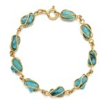 A turquoise-set bracelet, composed of a line of tumble polished turquoise in twist design cage
