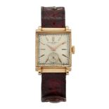 An 18ct gold wristwatch by Patek Philippe, the square silvered dial with applied gold baton