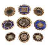 A group of nine 19th century gilt-mounted mourning brooches, comprising: five black enamel examples,