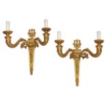 A pair of bronze and gilt bronze twin branch wall lights, 20th Century, designed with scrolling