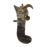 An Egyptian bronze feather from an atef crown surmounting a horn, Late Period to Ptolemaic, 664-30