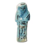 An Egyptian turquoise glazed composition shabti with black glazed details, holding two hoes, with