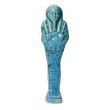 An Egyptian bright blue glazed composition shabti of typical form holding a pick and hoe with a