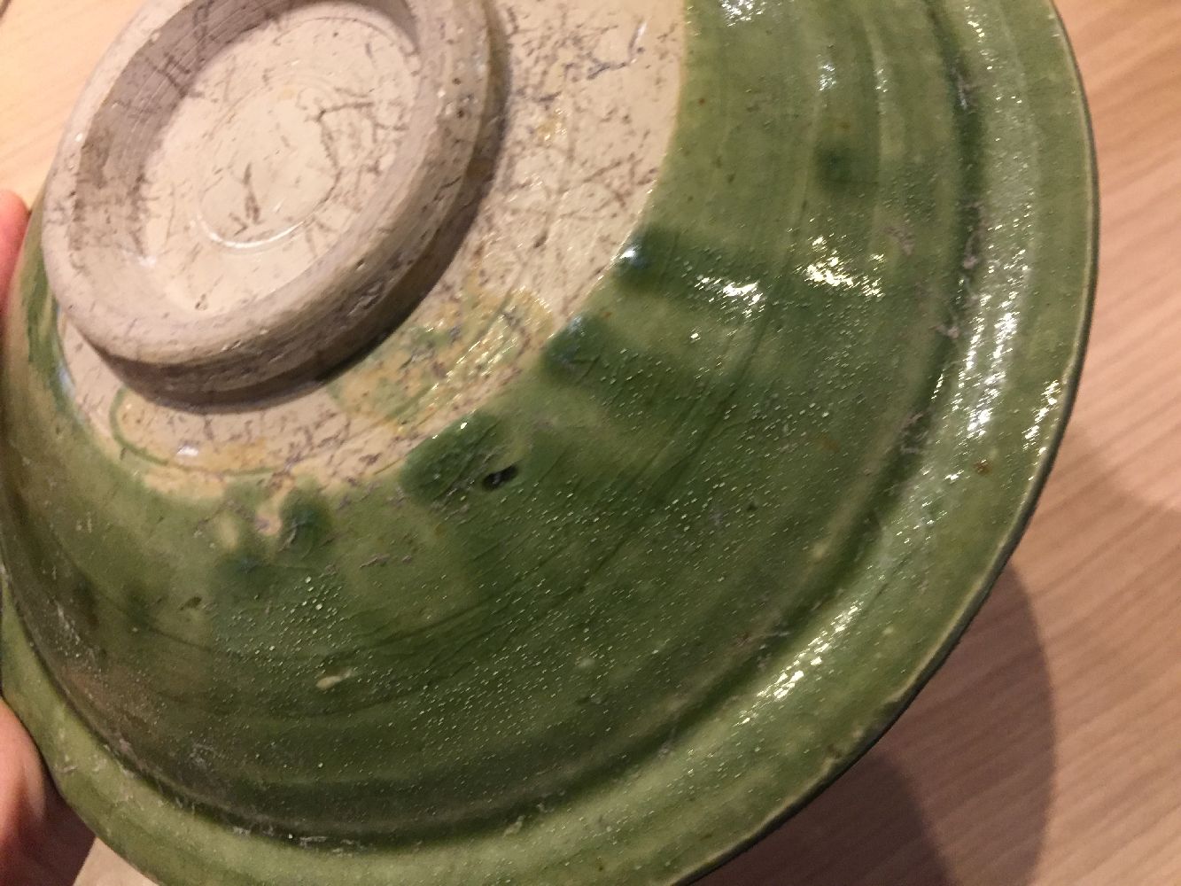 A Vietnamese stoneware green-glazed dish, 14th century, with pinched petal design to the interior - Image 4 of 13