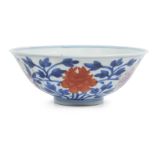 A Chinese porcelain 'peonies' bowl, Qianlong minyao mark and of the period, painted in underglaze