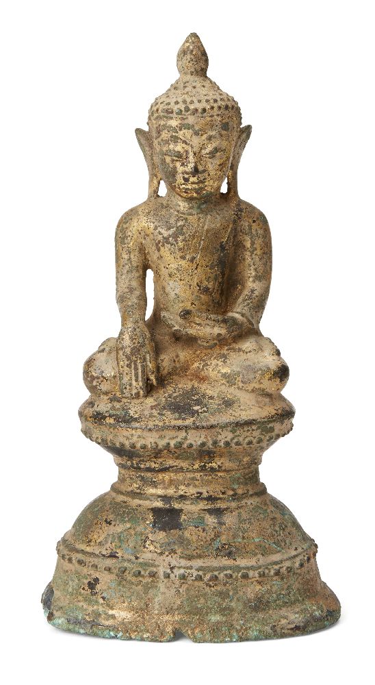 A Burmese extensively gilded bronze Buddha, Ava period, 18th century, seated with his right hand