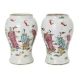 A pair of Chinese porcelain vases, Yongzheng period, painted in famille rose enamels with five of