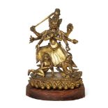 A Nepalese gilt bronze figure of Taeju-Bhawani, 18th century, finely cast standing on two kneeling