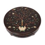 A Chinese hardwood circular box and cover, 18th century, inlaid with a carved ivory handle issuing