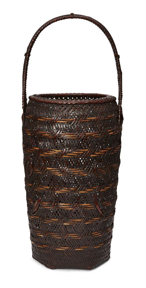 A Japanese tall Ikebana basket, early 20th century, of tubular form with woven handle, bamboo and