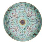 A Chinese porcelain 'sanduo' dish, 19th century, painted in famille rose enamels on a turquoise