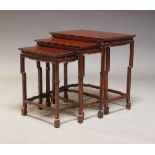 A Chinese stained wood nest of tables, 20th Century, the rectangular tops on curved supports on