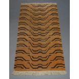 A Chinese rug with all over wave design in a pale orange field, 170cm x 91, together with a