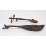 An Indonesian hasapi lute, Toba Batak, Sumatra, of boat-shaped form with carved figure riding an ox,
