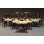 A Harlequin set of Victorian rosewood dining chairs, to include a set of five with carved splats,