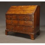 A mahogany bureau, late 19th, early 20th Century, the fall enclosing burgundy baize lined writing