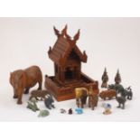 A group of Asian items, 20th century, to include: a wood temple model and a collection of animal