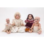 A group of four dolls, late 19th / early 20th Century, to include a French SFBJ doll, mould 60, on a