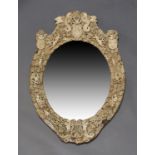 A Dieppe ivory and bone mirror, c.1870, the cresting centred by a coat-of-arms flanked by supporters