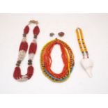 A red and white Naga bead necklace with brass spacers, composed of multiple strings of white and red