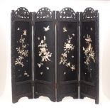 A Japanese carved hardwood shibayama style three-fold screen, early 20th Century, the panels