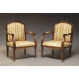 A pair of Louis XVI style stained beech fauteuils, 20th Century, the shaped backs with carved