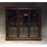 A stained wood bookcase, in the Georgian taste, late 20th Century, the moulded cornice above