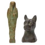 A green glazed composition shabti of typical form, holding the pick and hoe with plaited beard and